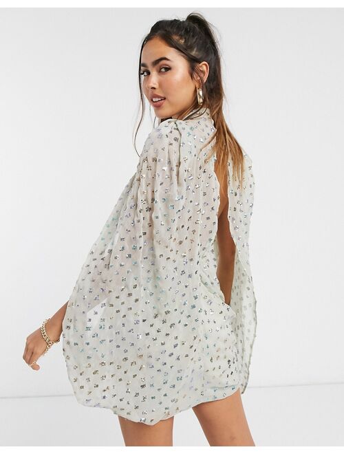 ASOS DESIGN sequin embellished cape sleeve mini dress with wrap skirt