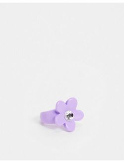 ring with purple flower in plastic