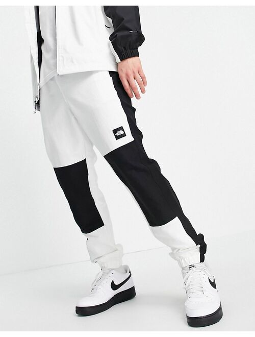 The North Face Black Box track pants in white/ black