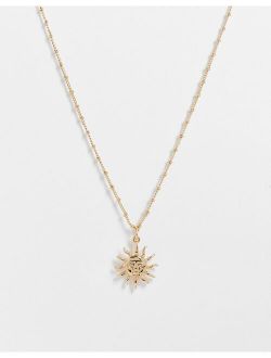 necklace with sun pendant in gold tone