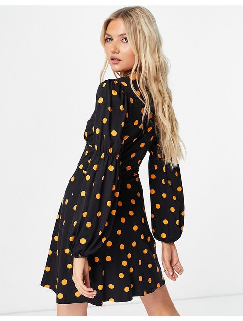 Asos Design mini tea dress with buttons and long sleeves in black and orange spot print