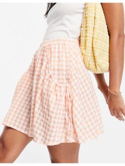 flippy mini skirt with ruched pocket in peach gingham print