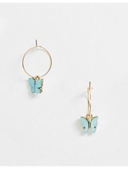 hoop earrings with blue butterfly charm in gold tone