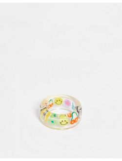 plastic ring with trapped kitsch charms in clear