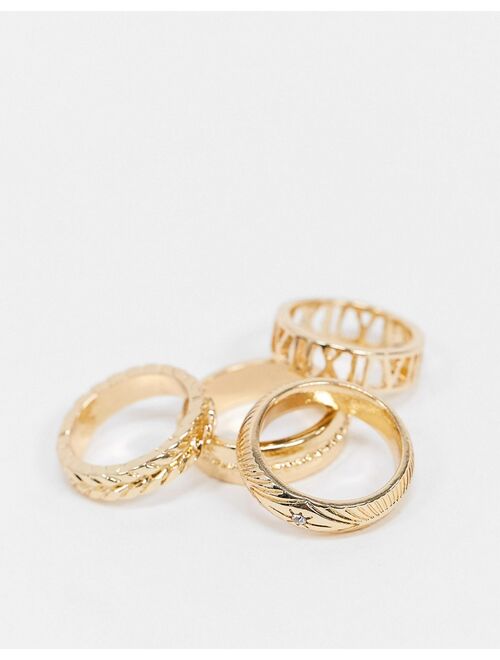 Asos Design pack of 4 rings in mixed texture and cut-out roman numerals in gold tone