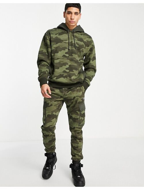 Champion small logo hoodie in camo