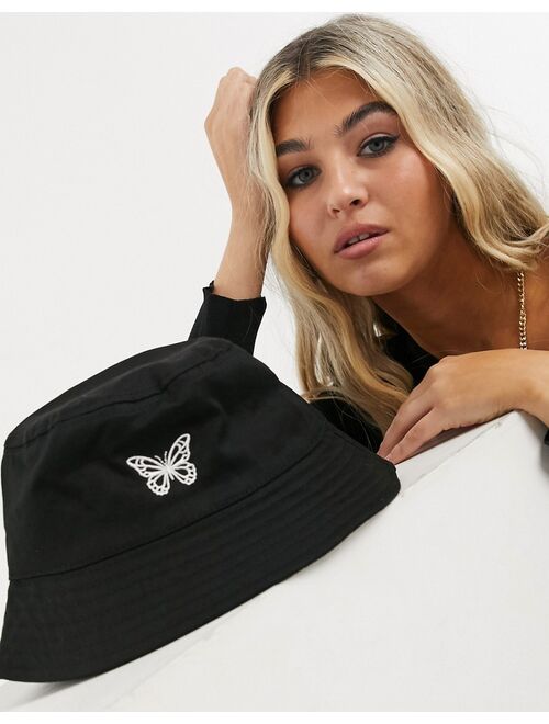Asos Design canvas bucket hat with butterfly logo in black