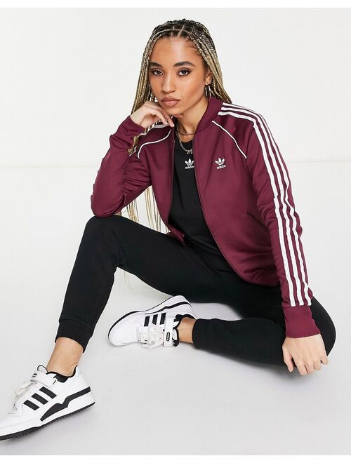 Adidas Originals Originals adicolor three stripe track top in crimson
