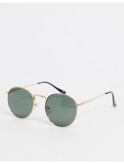 round sunglasses in gold metal with smoke lens