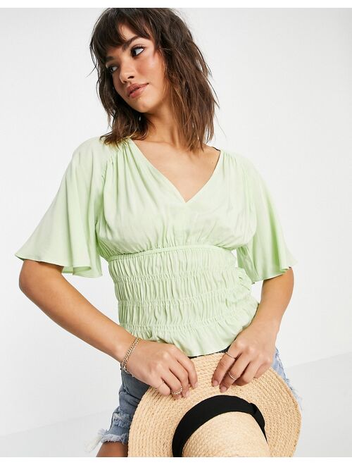 ASOS DESIGN v neck short sleeve top with shirred waist detail in pistachio