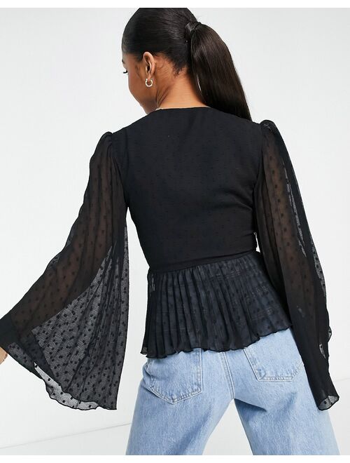 ASOS DESIGN textured pleated peplum top with button and tie detail with long sleeve in black