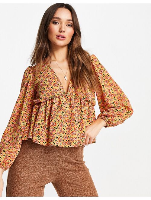 ASOS DESIGN v neck volume sleeve top with peplum hem in mustard print