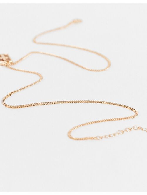 ASOS DESIGN skinny neckchain with tiger's eye stone and cross pendant in gold tone