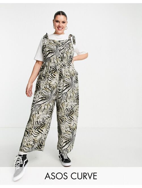 ASOS DESIGN curve spun tie shoulder button front overalls in animal print