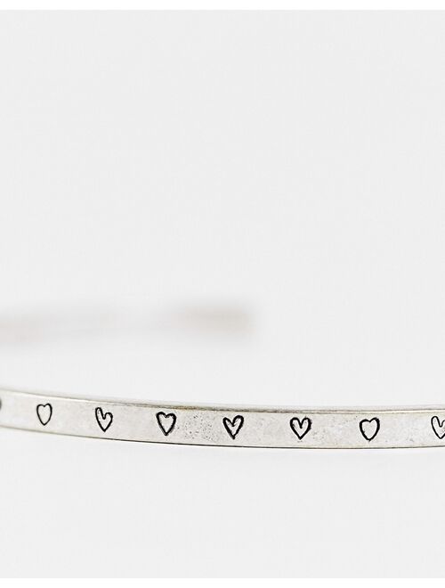ASOS DESIGN skinny cuff bracelet with heart detail in silver tone