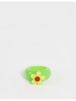 plastic ring with yellow flower in green