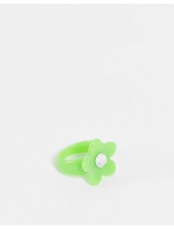 ring with green flower in plastic