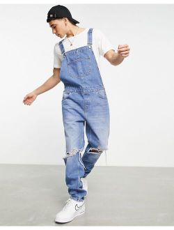 denim overalls in mid wash with knee rips