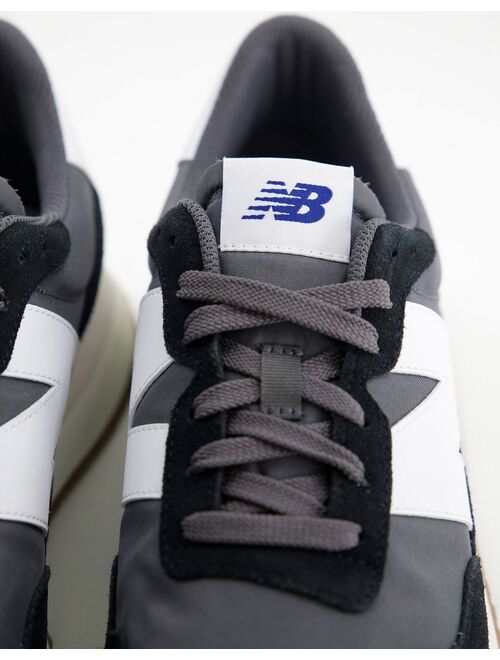 New Balance 237 sneakers in black with gum sole