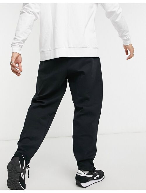 Reebok Techstyle DreamBlend drawstring tapered sweatpants in black