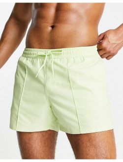 swim shorts with curved hem in lime green short length