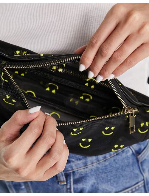 ASOS DESIGN fanny pack in organza with happy face embroidery in black