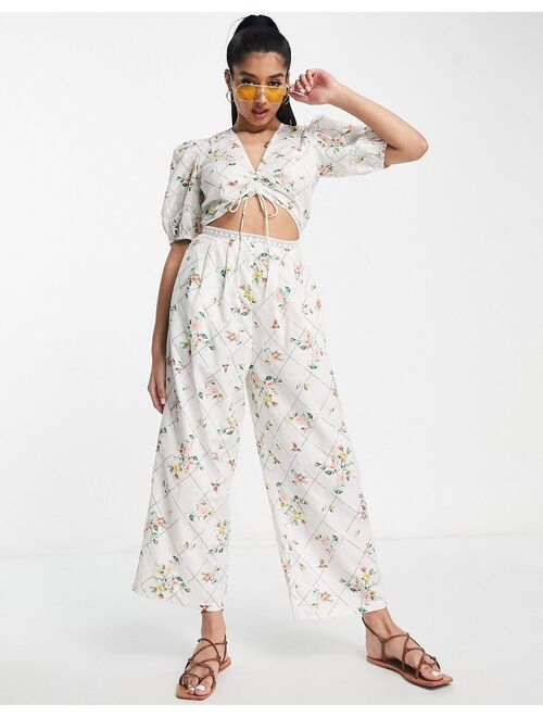 ASOS DESIGN lace insert cut out jumpsuit with puff sleeve in floral grid print