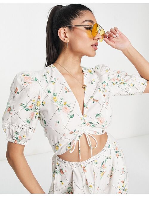 ASOS DESIGN lace insert cut out jumpsuit with puff sleeve in floral grid print