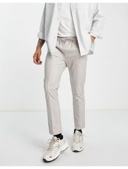 skinny chinos with pin tuck and elasticized waist in stone
