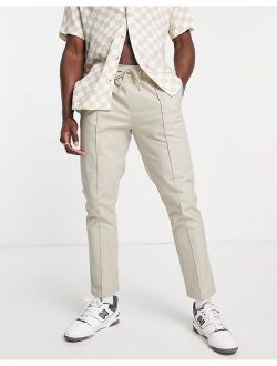 slim chinos with pin tucks and elasticated waist in light beige