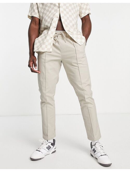ASOS DESIGN slim chinos with pin tucks and elasticated waist in light beige