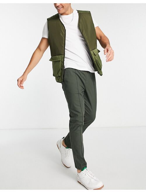 ASOS DESIGN skinny chinos with pin tuck and elastic waist in dark green