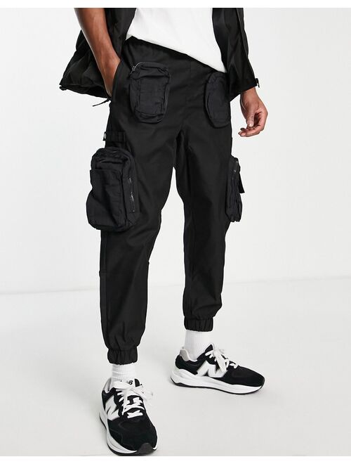 Bershka utility cargo pants with pockets in black