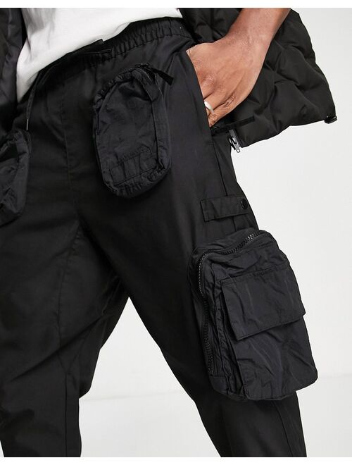 Bershka utility cargo pants with pockets in black