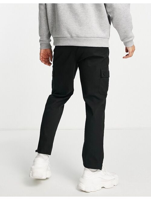 ASOS DESIGN tapered cargo pants in black with toggles