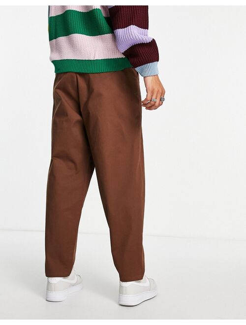 ASOS DESIGN oversized tapered chinos with pin tuck in brown