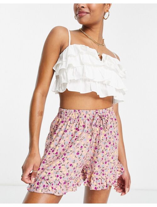 ASOS DESIGN Petite elasticated waist short with frill hem in pink based floral