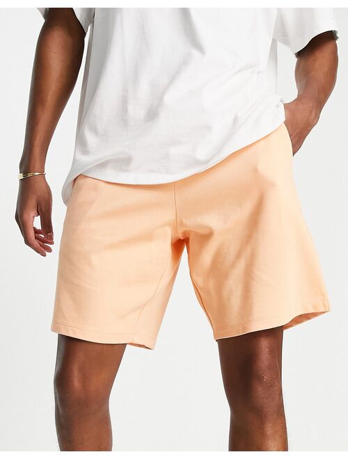 ASOS DESIGN oversized jersey shorts in washed orange