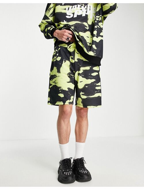 ASOS DESIGN ASOS Unrvlld Spply longline jersey shorts with logo in all-over print in green - part of a set