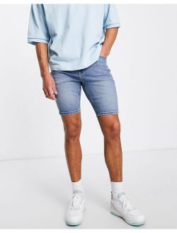 skinny denim shorts in mid wash blue