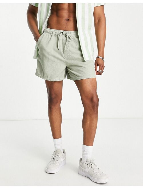 ASOS DESIGN wide fit shorts in light green cord