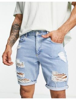 slim denim shorts with heavy rips in light wash