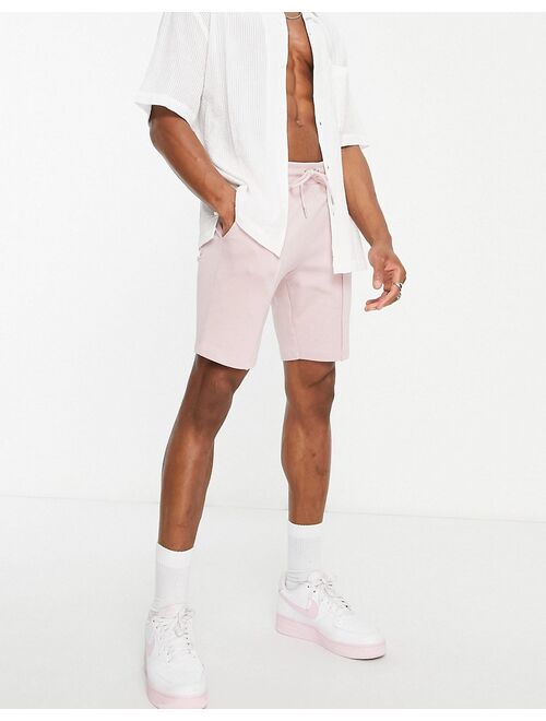 ASOS DESIGN jersey skinny shorts with pin tucks in pink