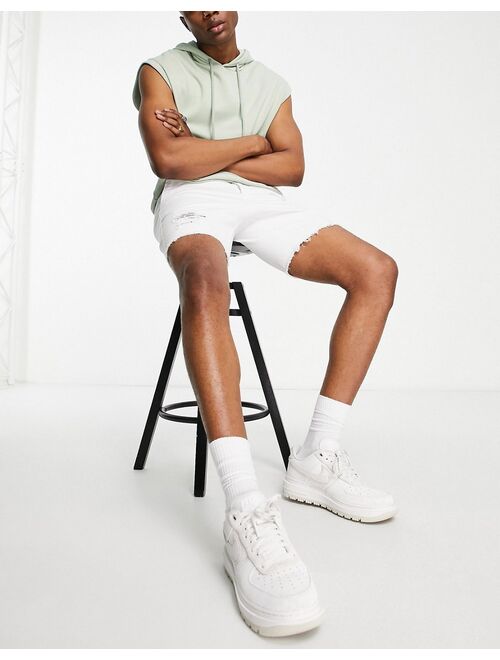 ASOS DESIGN skinny shorts with rips in white
