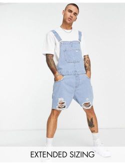 short denim overalls in light wash with rips