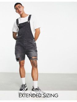 short denim overalls in washed black with heavy rips