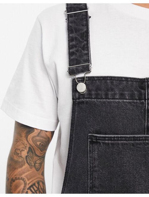 ASOS DESIGN short denim overalls in washed black with heavy rips
