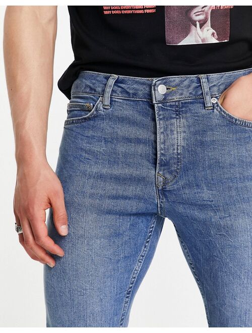 Topman stretch tapered jeans in mid wash