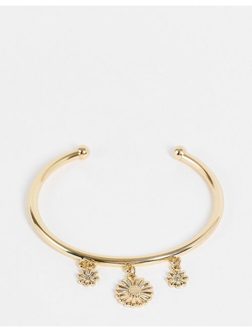 ASOS DESIGN bangle bracelet with daisy charms in gold tone