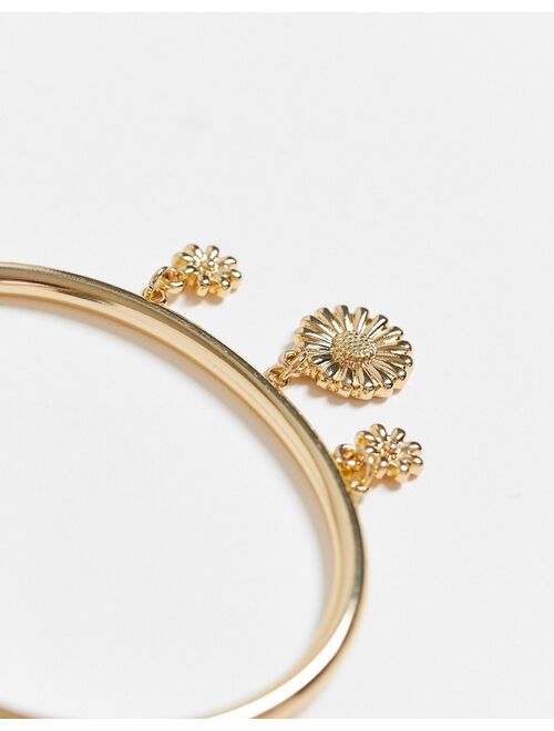 ASOS DESIGN bangle bracelet with daisy charms in gold tone